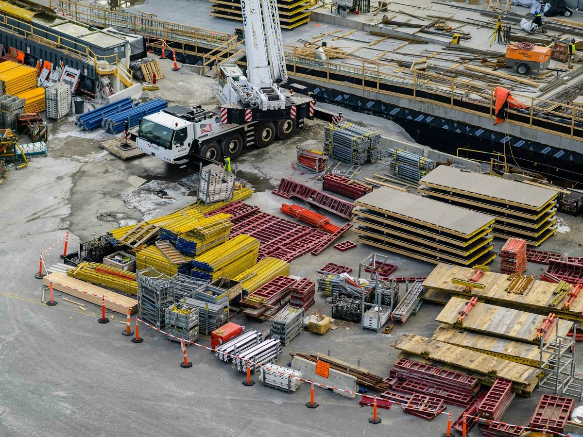 Mega Structure heavy equipment fleet — mobile crane, trucks and plant staged at the yard